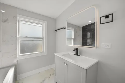 a bathroom with a sink and a mirror