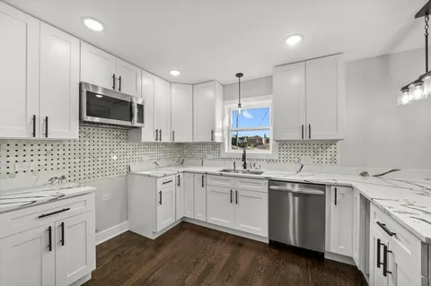 a kitchen with a sink stove and microwave