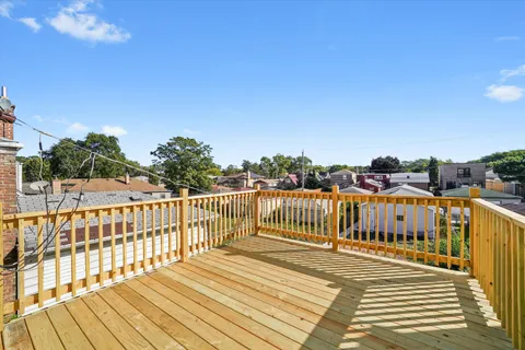 a view of a rooftop deck and city view