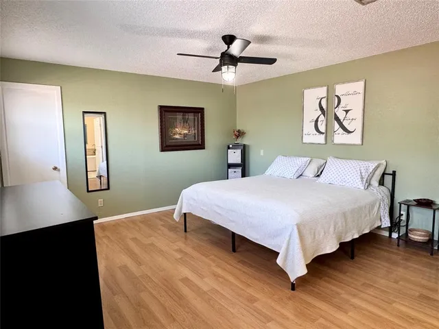 a bedroom with a large bed and a chandelier