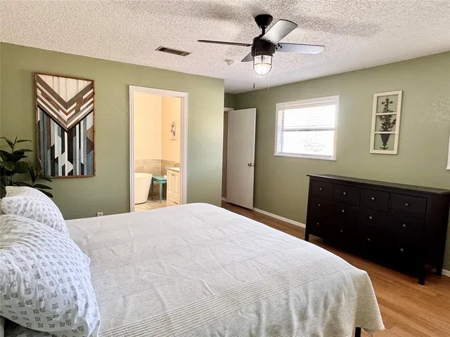 a bedroom with a bed and a dresser