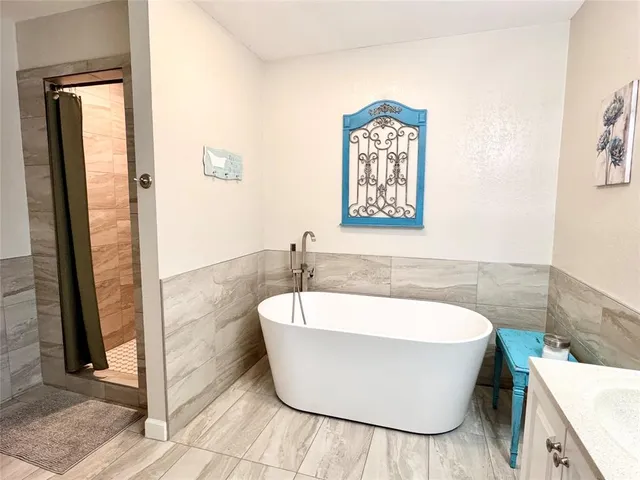 a white bath tub sitting in a bathroom