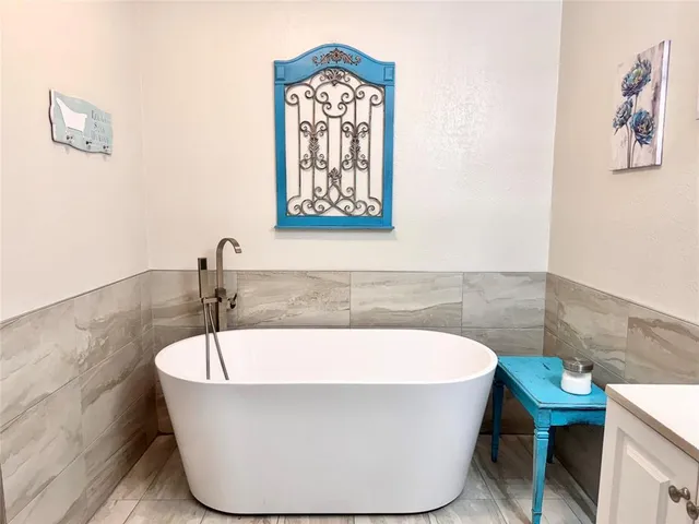 a white bath tub sitting in a bathroom