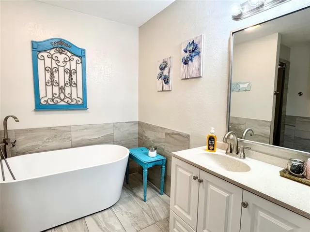 a bathroom with a bathtub a sink and a window