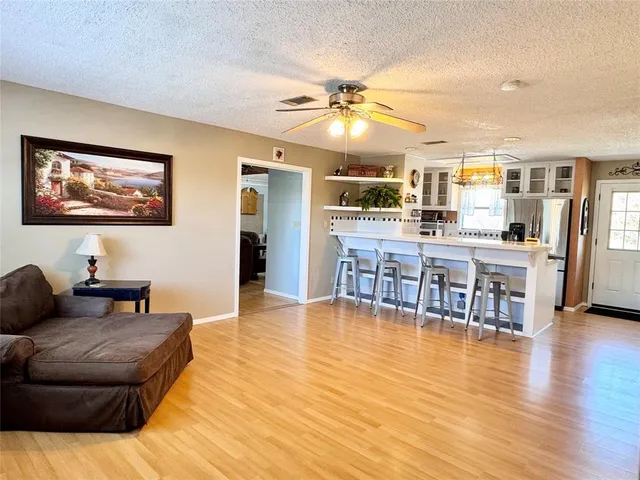 a living room with furniture and kitchen view