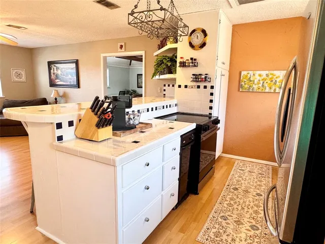 a kitchen with a stove and a refrigerator