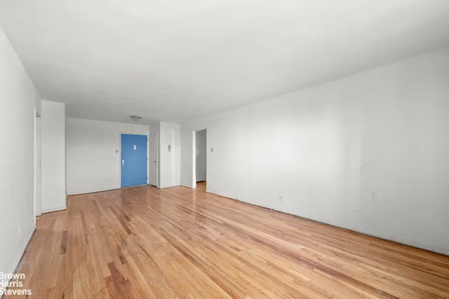 a view of an empty room and wooden floor