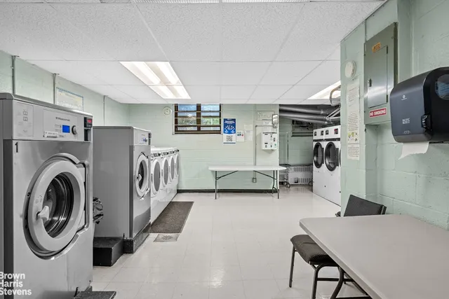 a living room with furniture and large windows