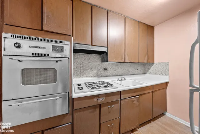 a view of a room with wooden floor and window