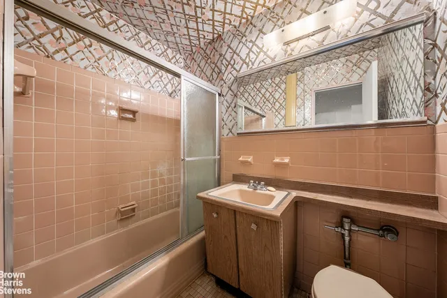 a kitchen with a refrigerator and a stove top oven