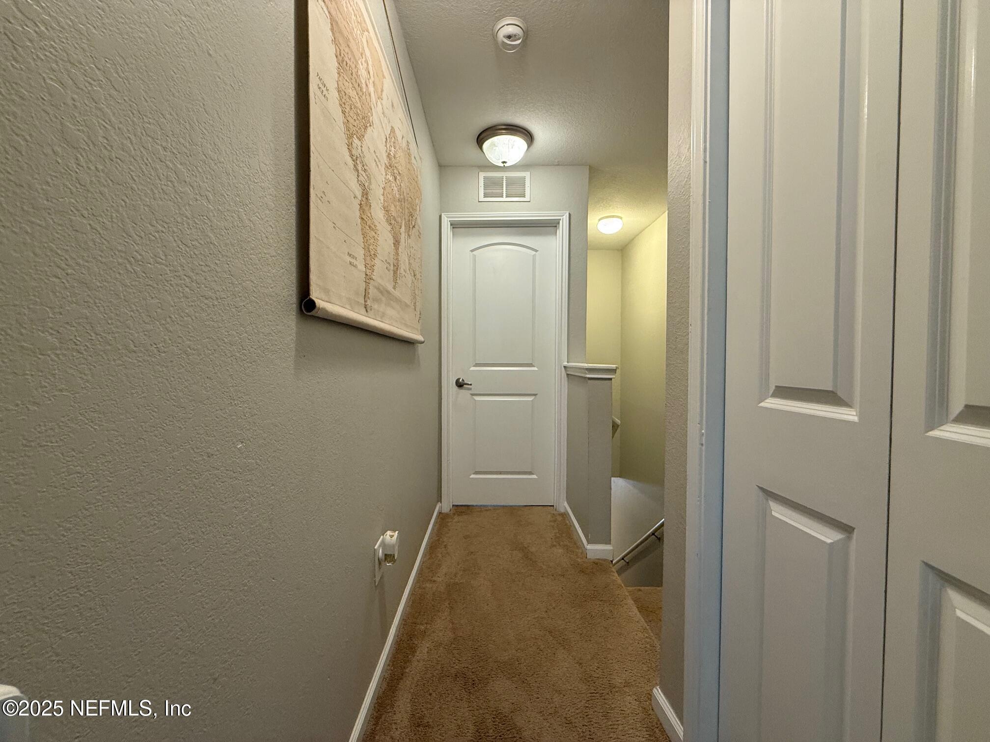 10200 Belle Rive Boulevard, Unit 4905 Jacksonville, FL 32256 - Photo 15 of 25 a view of a hallway with wooden floor