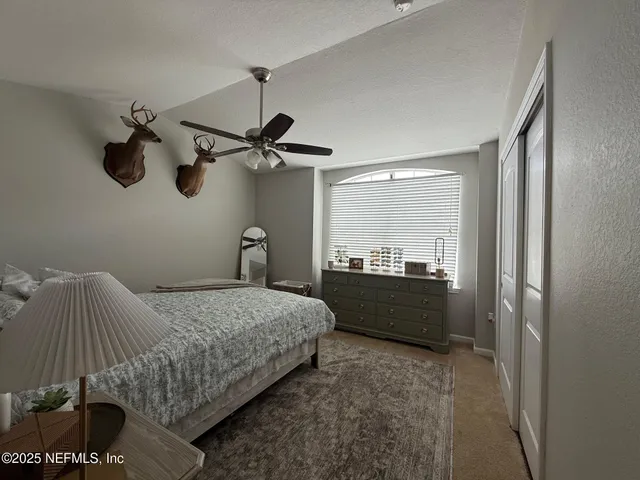 a bedroom with a bed and a walk in closet