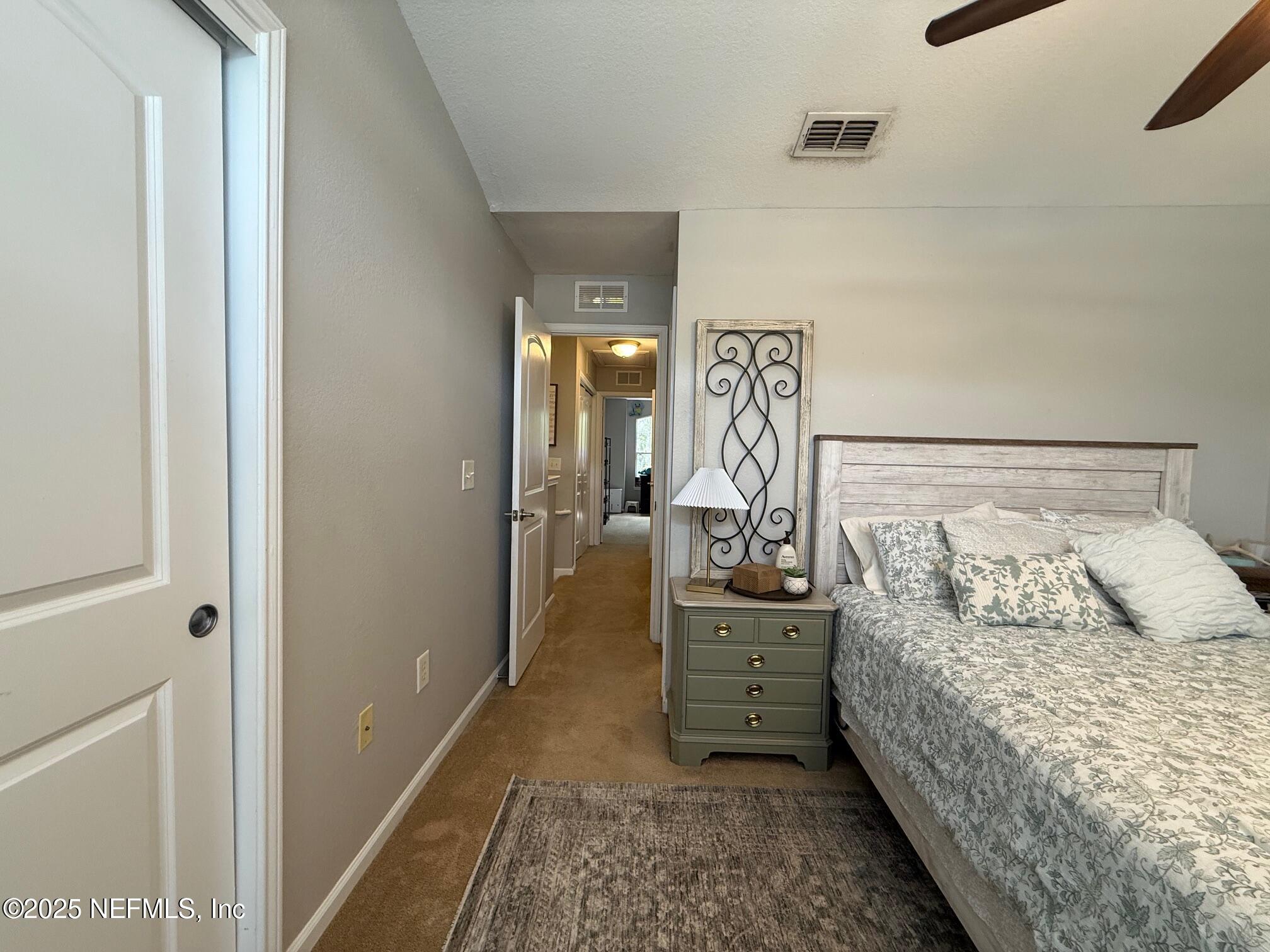 10200 Belle Rive Boulevard, Unit 4905 Jacksonville, FL 32256 - Photo 18 of 25 a bedroom with a bed and a walk in closet