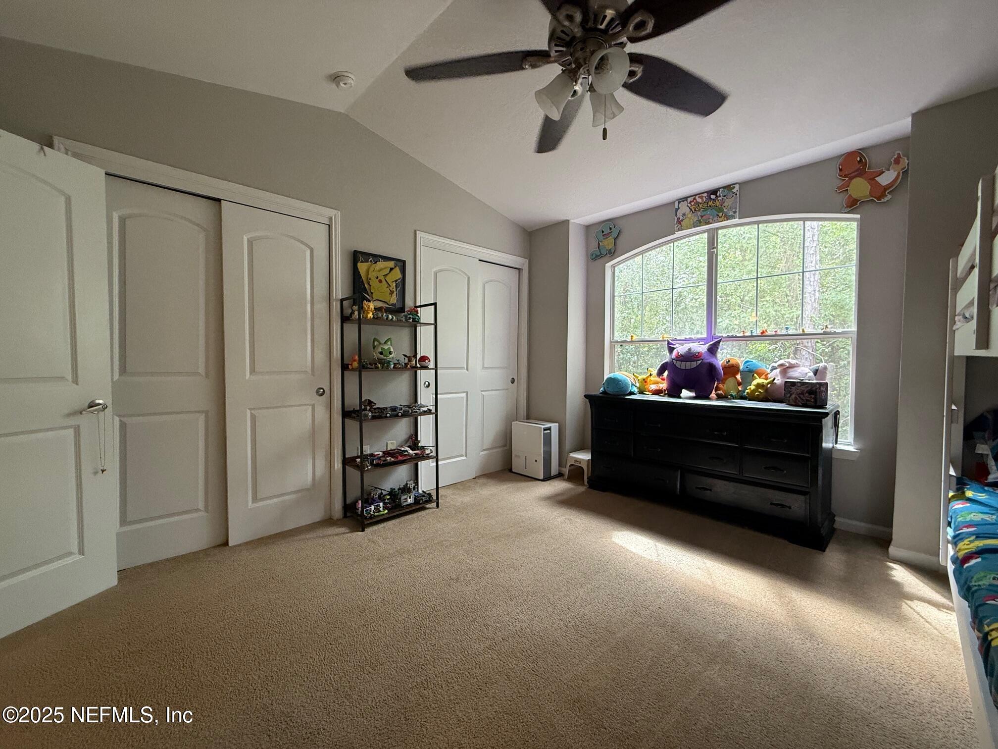 10200 Belle Rive Boulevard, Unit 4905 Jacksonville, FL 32256 - Photo 21 of 25 a living room with furniture and a flat screen tv