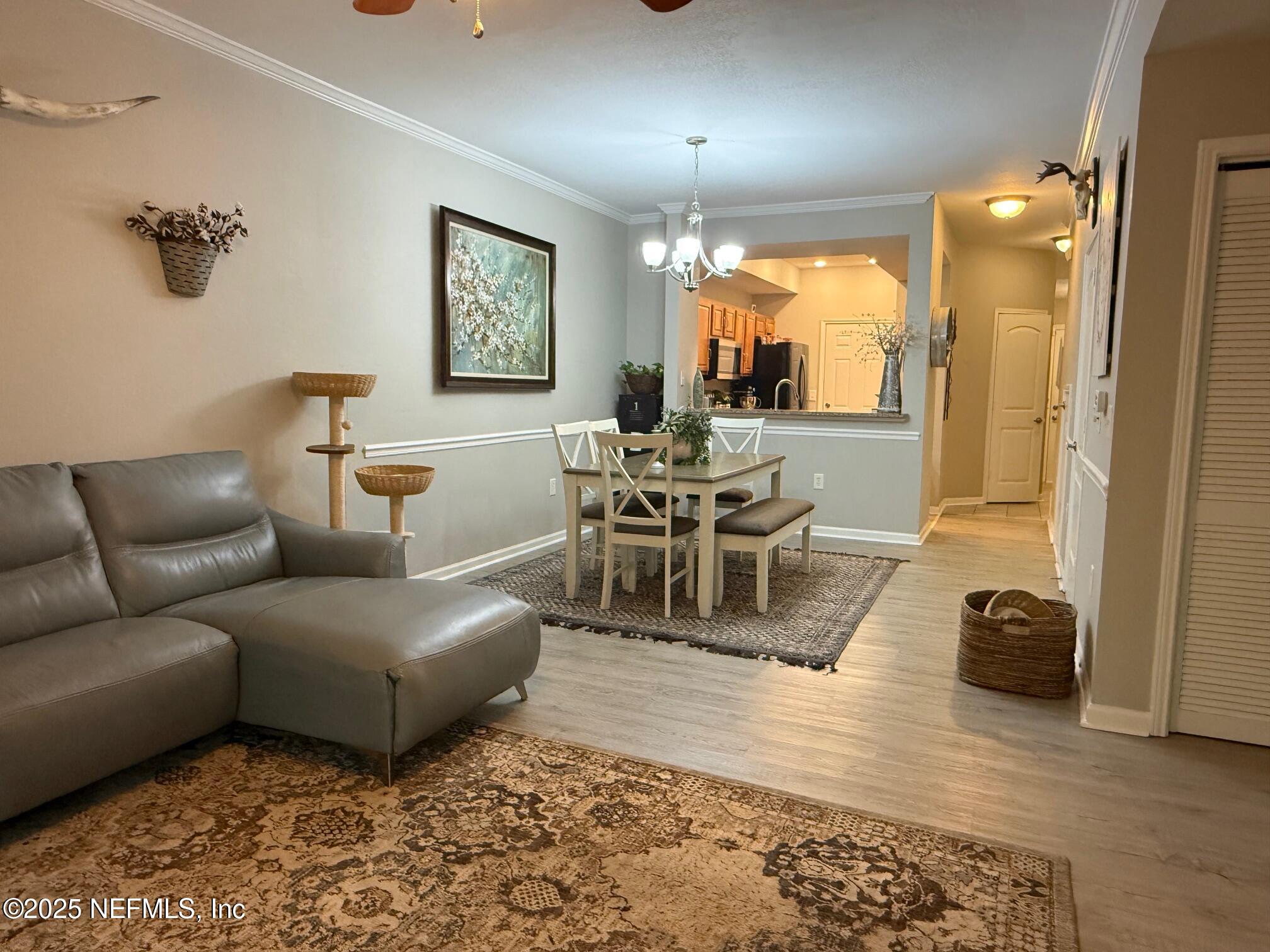 10200 Belle Rive Boulevard, Unit 4905 Jacksonville, FL 32256 - Photo 9 of 25 a living room with furniture and a large window