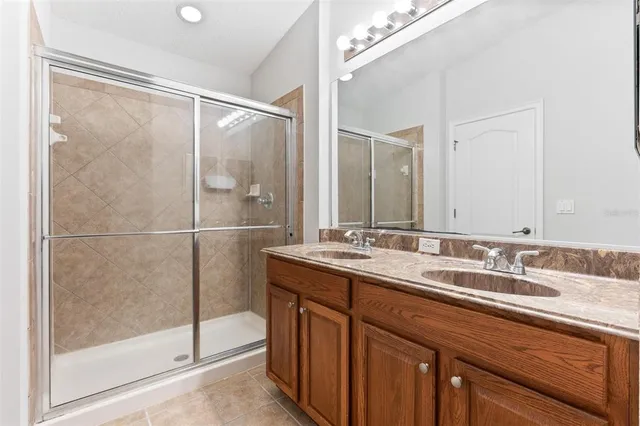 a bathroom with a double vanity sink and mirror