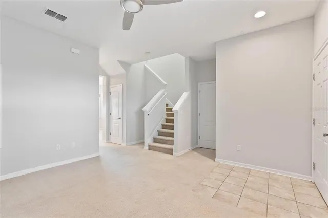 a view of an empty room with stairs and ventilation