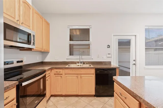 a kitchen with stainless steel appliances granite countertop a sink stove oven and granite counter tops