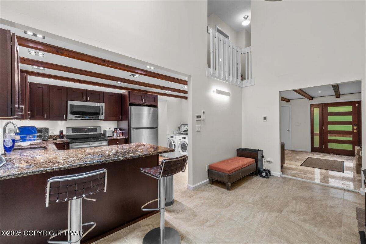 1289 Bear Drive Bushkill, PA 18324 - Photo 17 of 40 a kitchen with stainless steel appliances granite countertop a sink stove and refrigerator