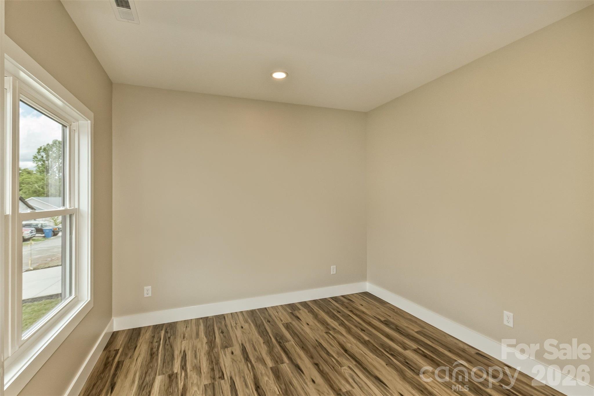112 Peyton Elaine Road Clyde, NC 28721 - Photo 18 of 35 an empty room with wooden floor and windows