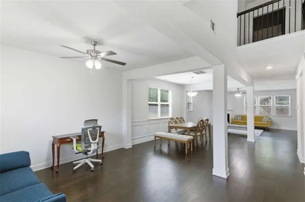 a living room with furniture and wooden floor