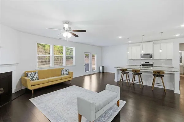 a living room with furniture and kitchen view