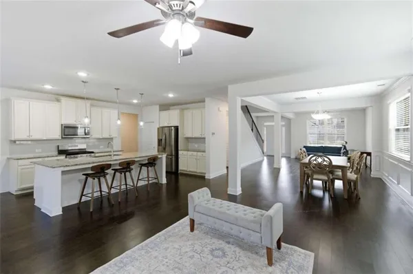 a living room with furniture kitchen view and a dining table