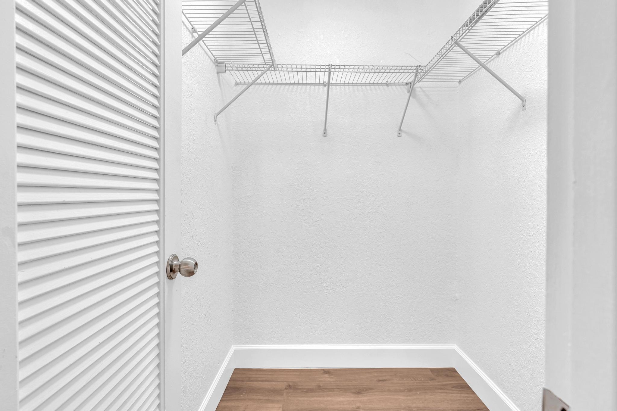 1291 Northwest 13th Street, Unit 445D Boca Raton, FL 33486 - Photo 36 of 50 a view of a room with racks on the wall
