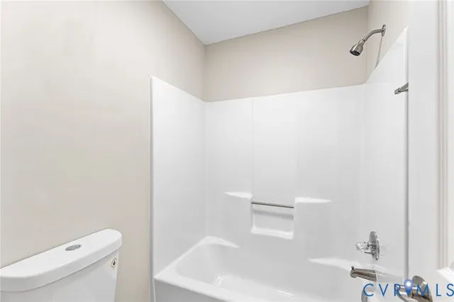 a white bath tub sitting next to a white toilet and sink