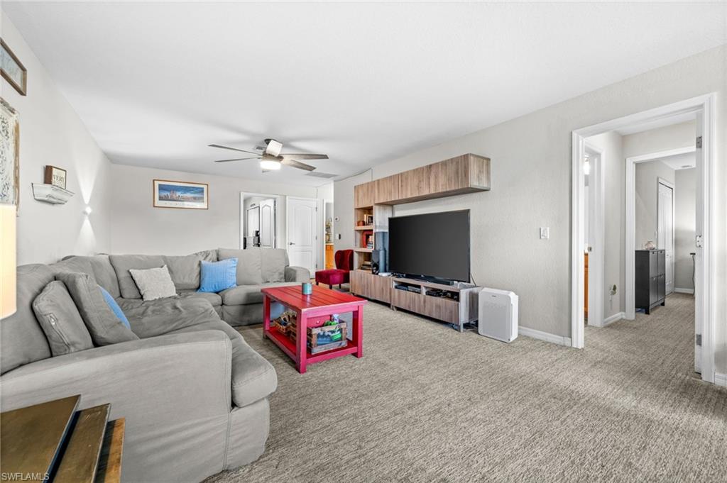 4754 Abaca Circle Naples, FL 34119 - Photo 17 of 46 a living room with furniture and a flat screen tv