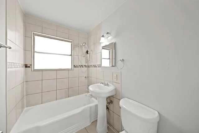 a view of a yard in front of a house with large trees