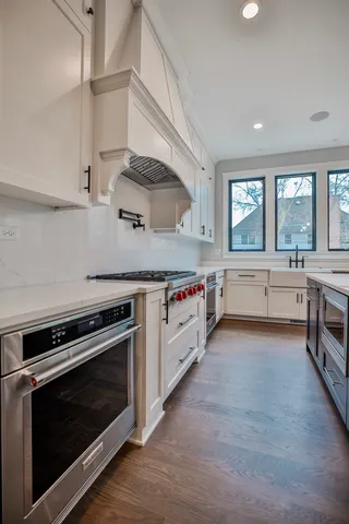 a kitchen with stainless steel appliances granite countertop a stove and a sink