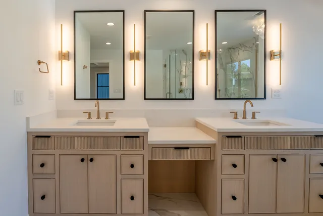 a bathroom with double sink and a mirror