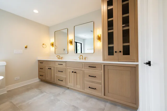 a spacious bathroom with a granite countertop sink and a mirror