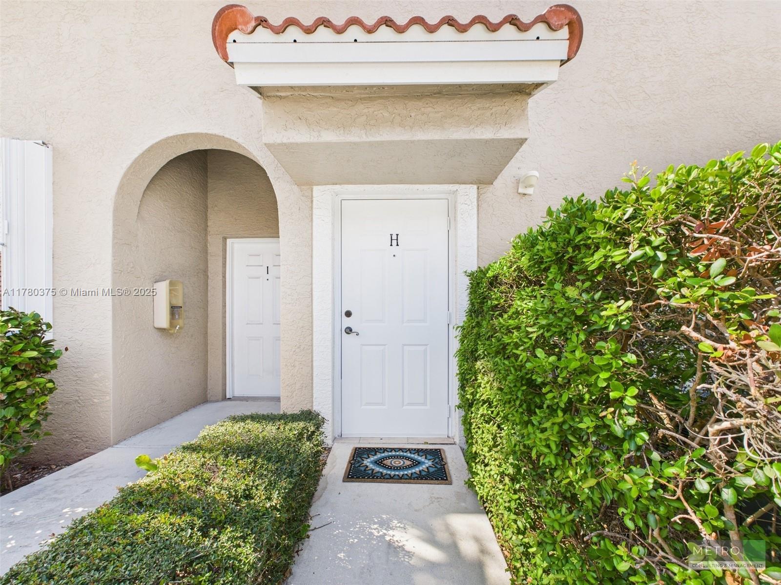 112 Lighthouse Circle, Unit H Tequesta, FL 33469 - Photo 1 of 20 a front view of a house with a garden