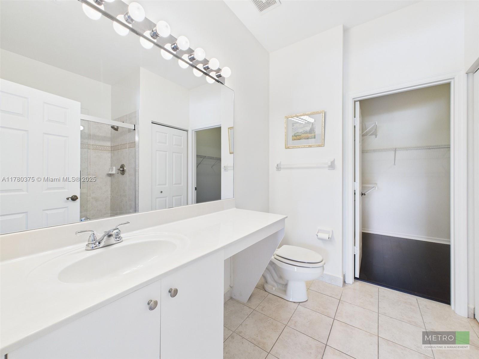 112 Lighthouse Circle, Unit H Tequesta, FL 33469 - Photo 12 of 20 a spacious bathroom with a sink toilet and a mirror