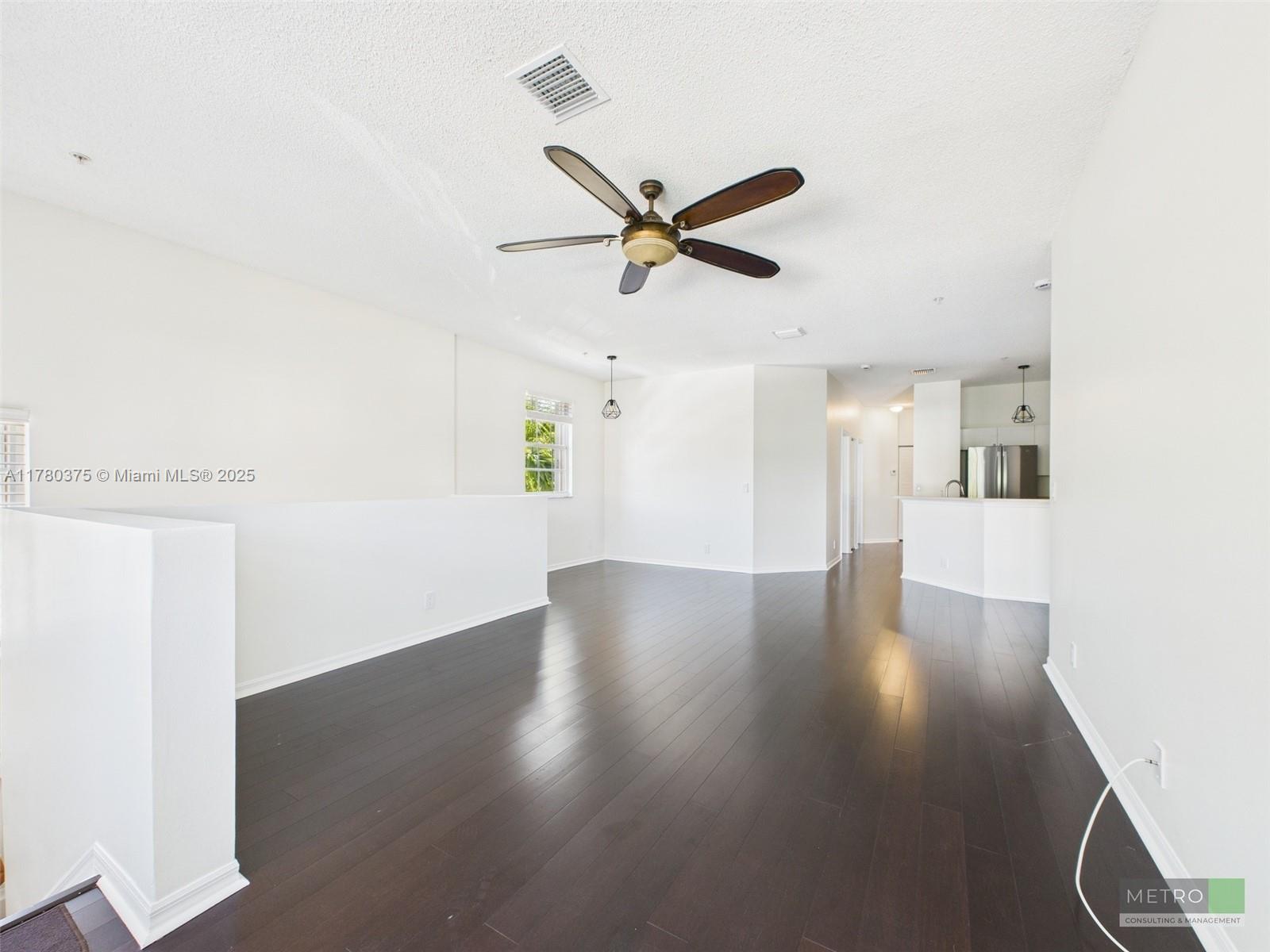 112 Lighthouse Circle, Unit H Tequesta, FL 33469 - Photo 5 of 20 a view of a livingroom with a ceiling fan and wooden floor