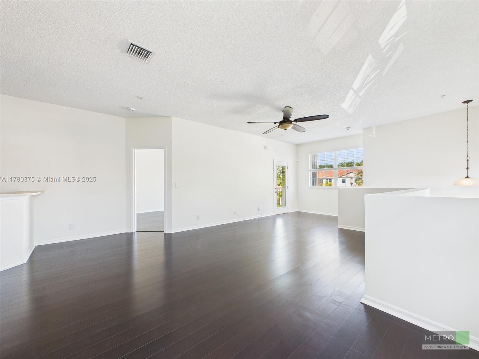 112 Lighthouse Circle, Unit H Tequesta, FL 33469 - Photo 7 of 20 a view of an empty room with wooden floor