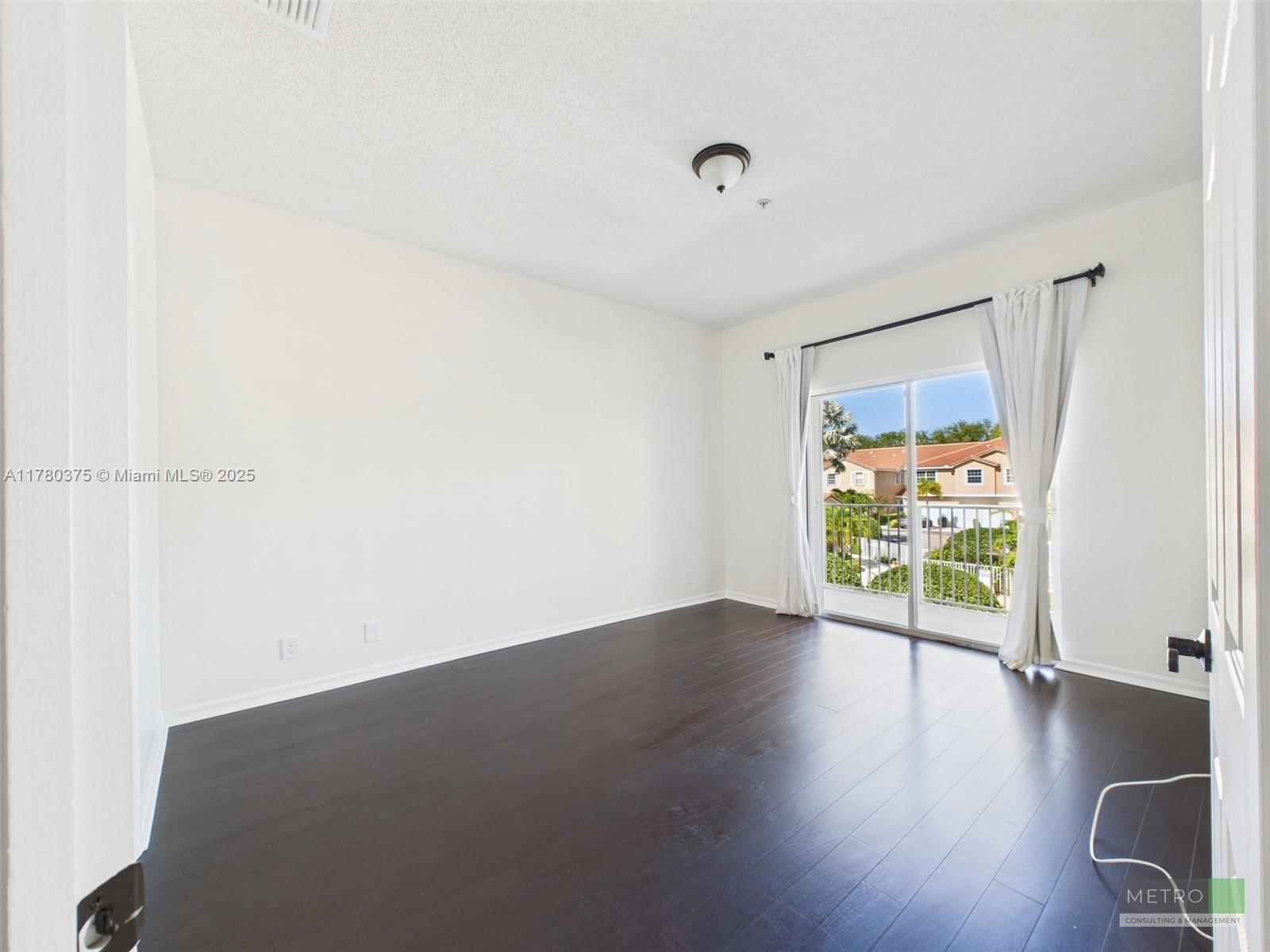 112 Lighthouse Circle, Unit H Tequesta, FL 33469 - Photo 9 of 20 an empty room with wooden floor and windows
