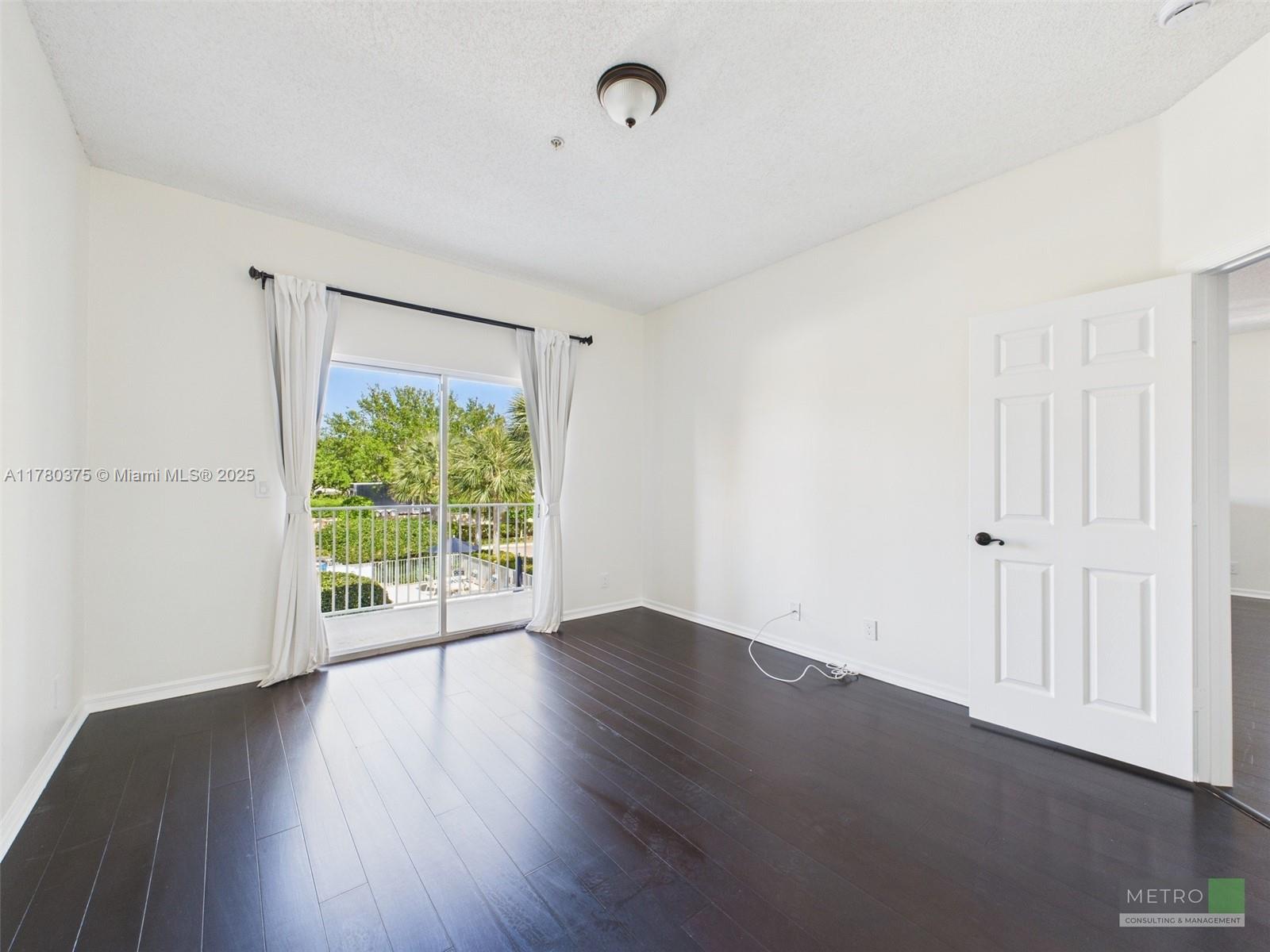 112 Lighthouse Circle, Unit H Tequesta, FL 33469 - Photo 10 of 20 an empty room with wooden floor and windows