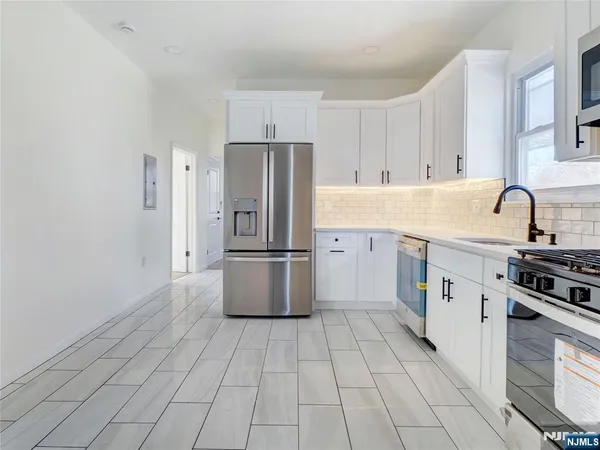 a kitchen with a sink appliances and cabinets