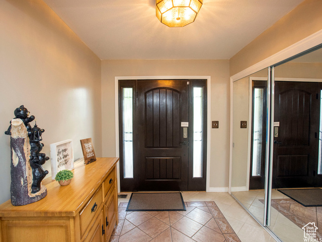 588 Raspberry Patch Road Garden City, UT 84028 - Photo 11 of 74 Entryway with light tile patterned flooring and baseboards