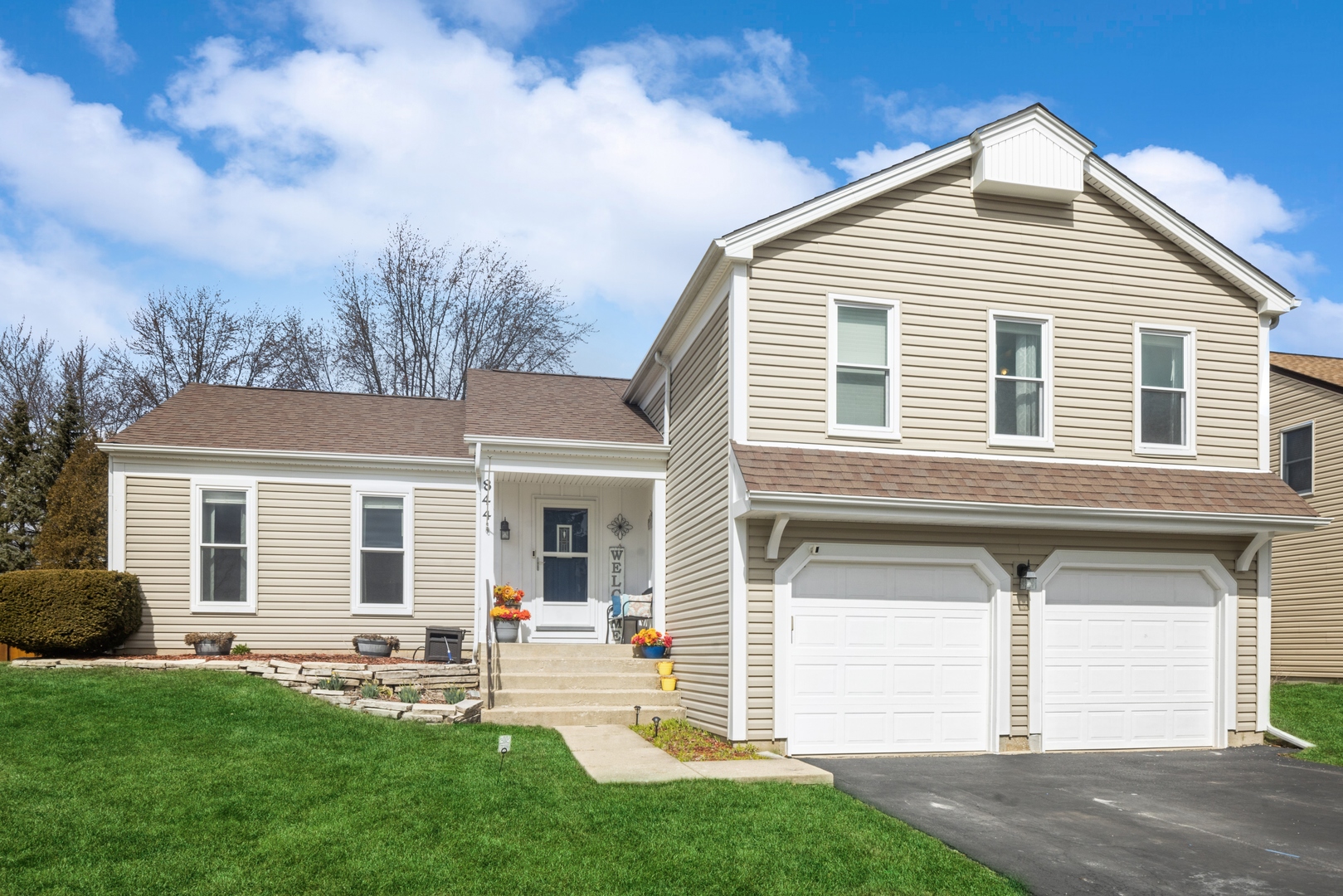 a front view of a house with a yard and garage