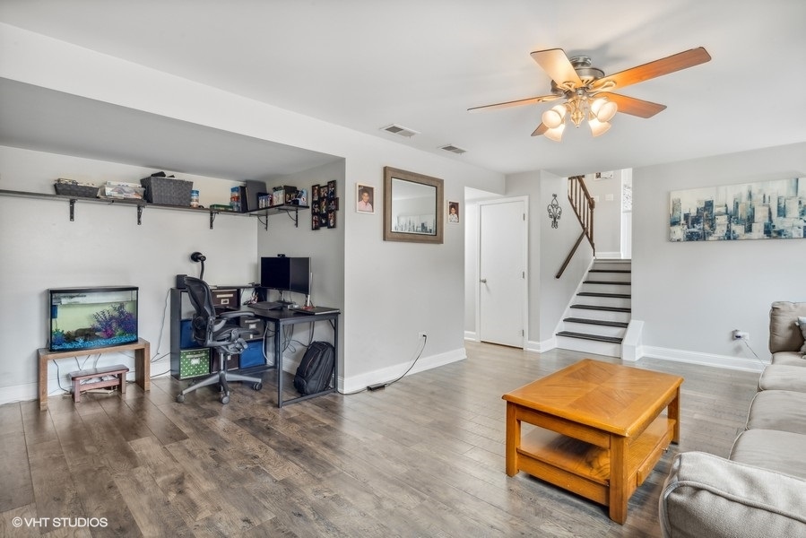 844 Burning Trail Carol Stream, IL 60188 - Photo 18 of 21 a living room with furniture and a dining table with wooden floor