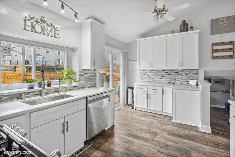 844 Burning Trail Carol Stream, IL 60188 - Photo 2 of 21 a kitchen with kitchen island granite countertop a sink cabinets and window