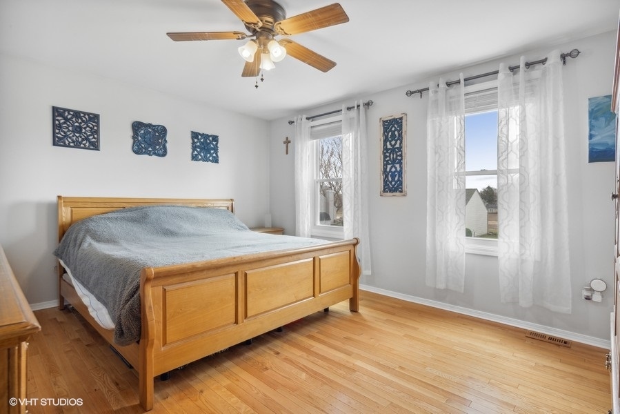 844 Burning Trail Carol Stream, IL 60188 - Photo 8 of 21 a bedroom with a bed and a chandelier