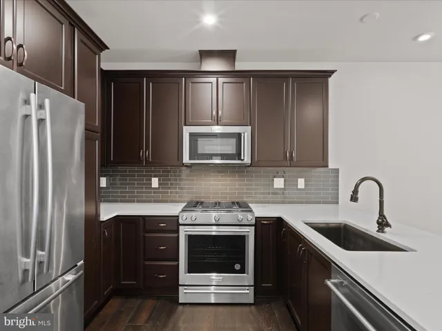 a kitchen with a sink and a refrigerator