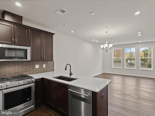a kitchen with a stove a sink and a microwave