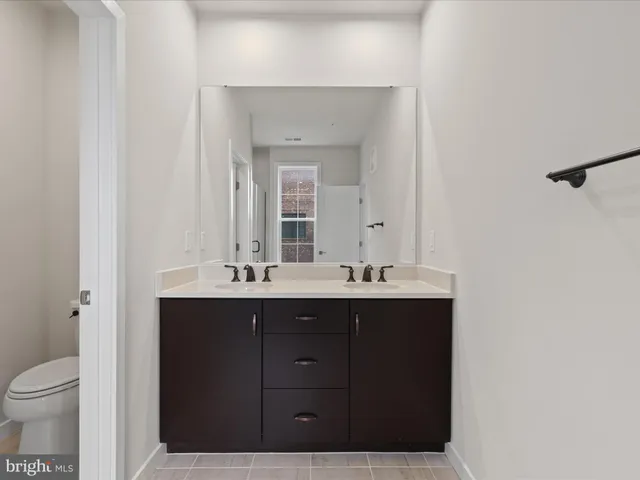 a bathroom with a sink vanity and mirror