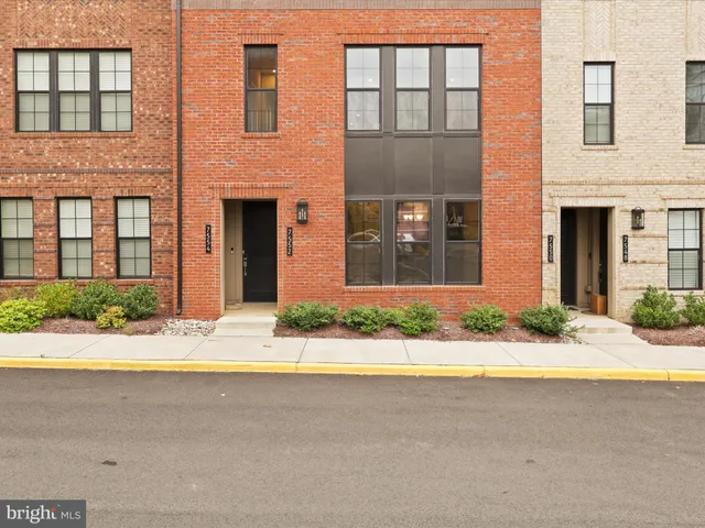 a front view of brick house with a yard